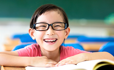 Smiling child reading a book